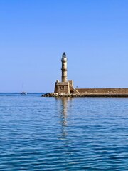 A light house sitting on top of a body of water photo – ...