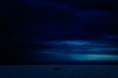 Dark Evening Blue Cloudy Alone Boat In Ocean