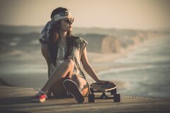 Girl On Beach With Skateboard