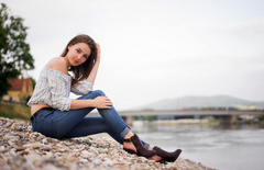 Girl Sitting Rocks Hands In Hair Looking